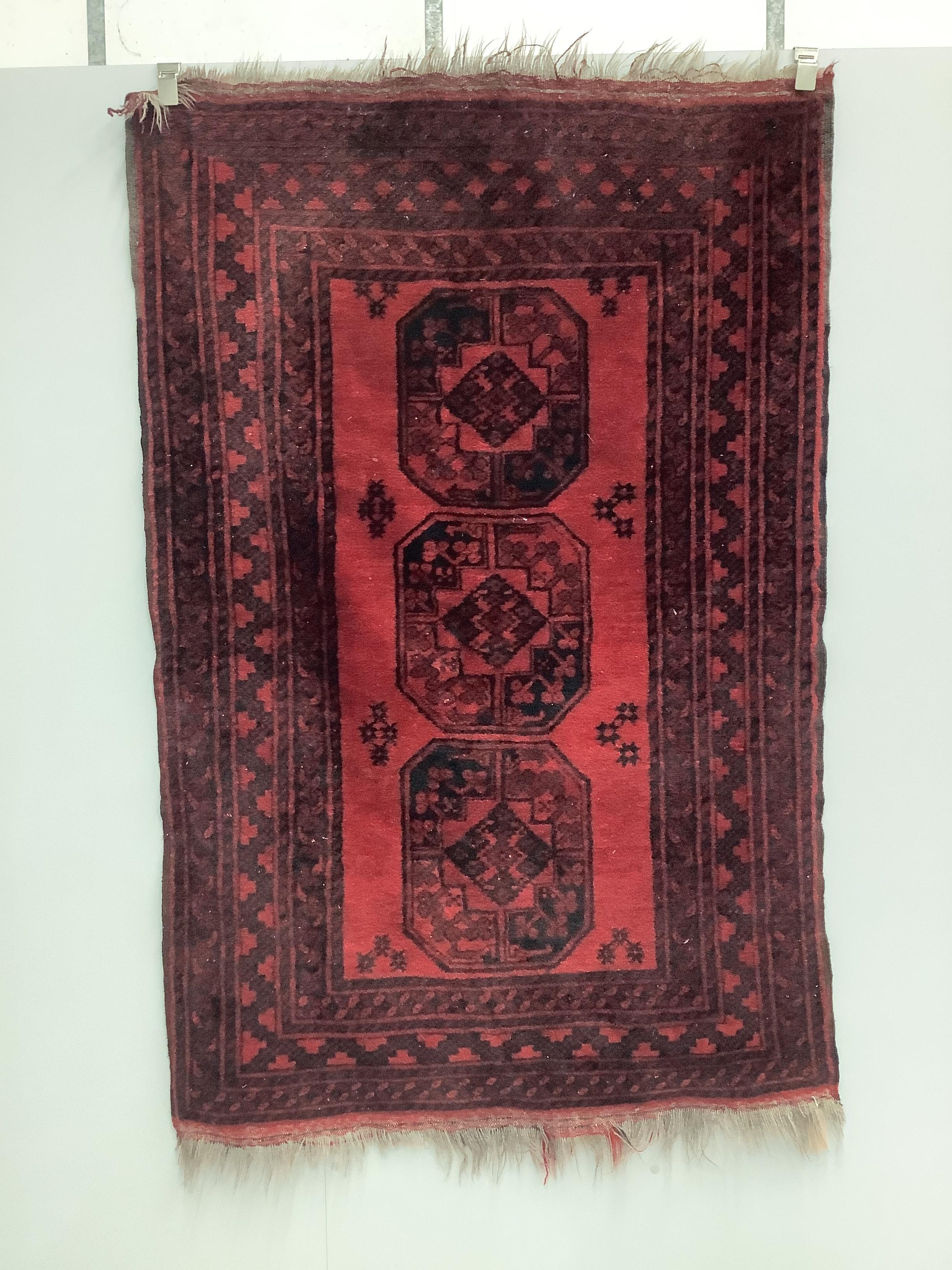 Two Afghan red ground rugs, larger 170 x 120cm